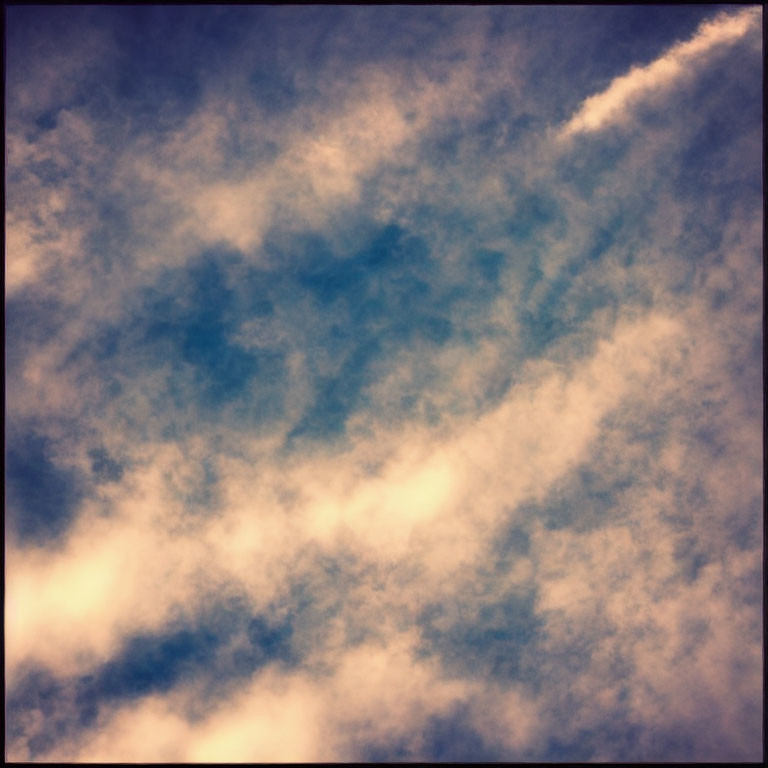 Serene sky with white and dark clouds under diffused sunlight