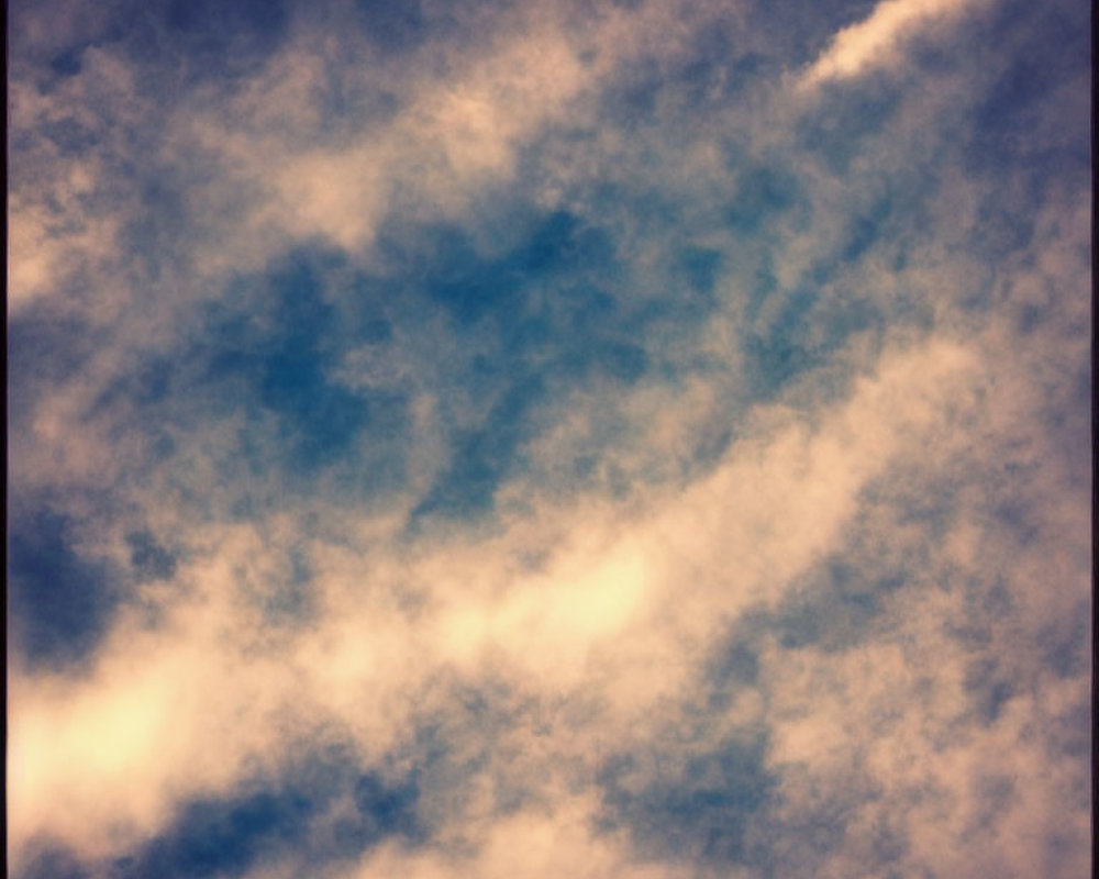 Serene sky with white and dark clouds under diffused sunlight