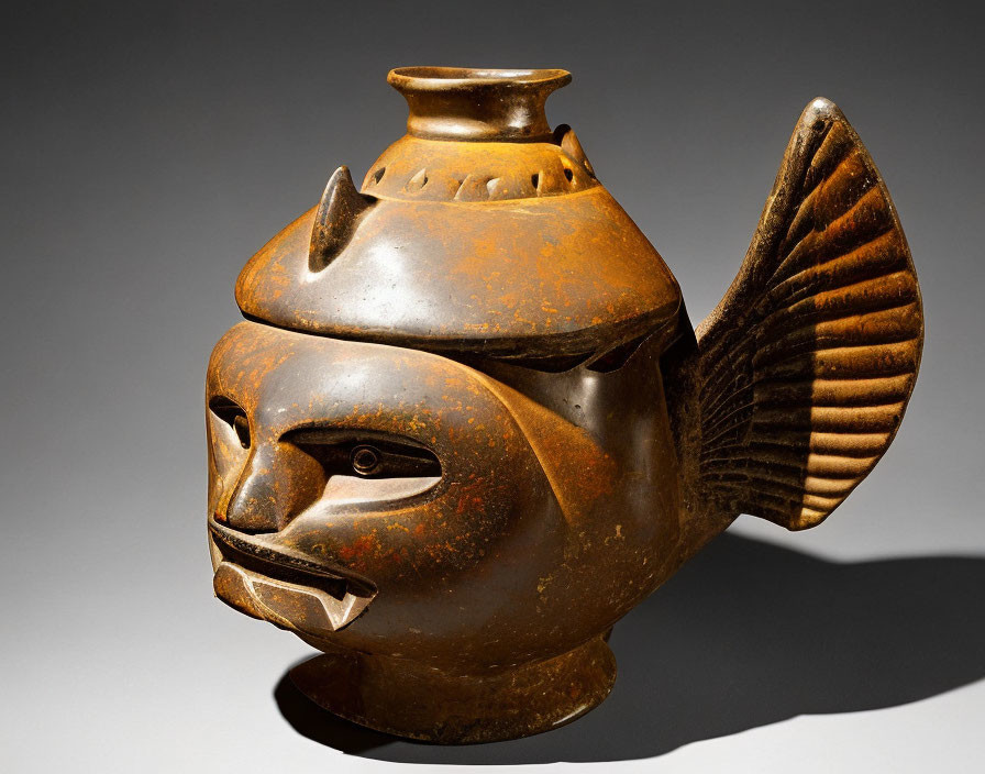 Stylized fish-shaped ceramic vessel with human-like face and spout