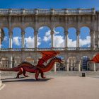 Red Dragon Sculpture in Plaza with White Arcades and Lampposts