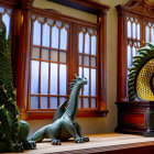 Ornate dragon sculptures on wooden windowsill with stained glass window