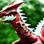 Intricate red dragon statue against green background