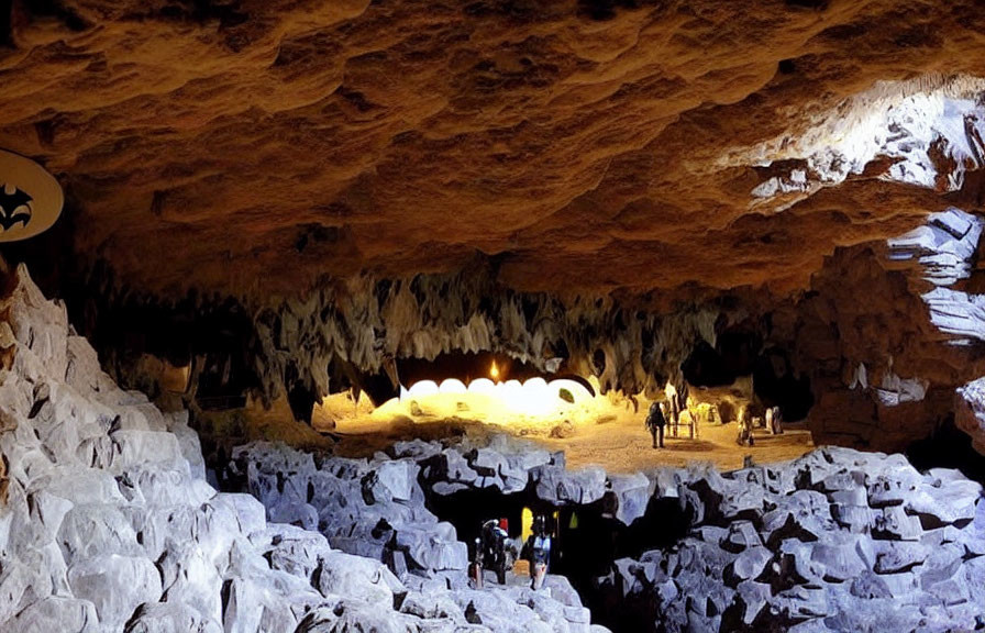 Spacious cavern with glowing stalactites and rocky formations