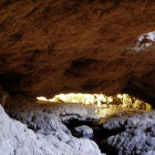 Spacious cavern with glowing stalactites and rocky formations