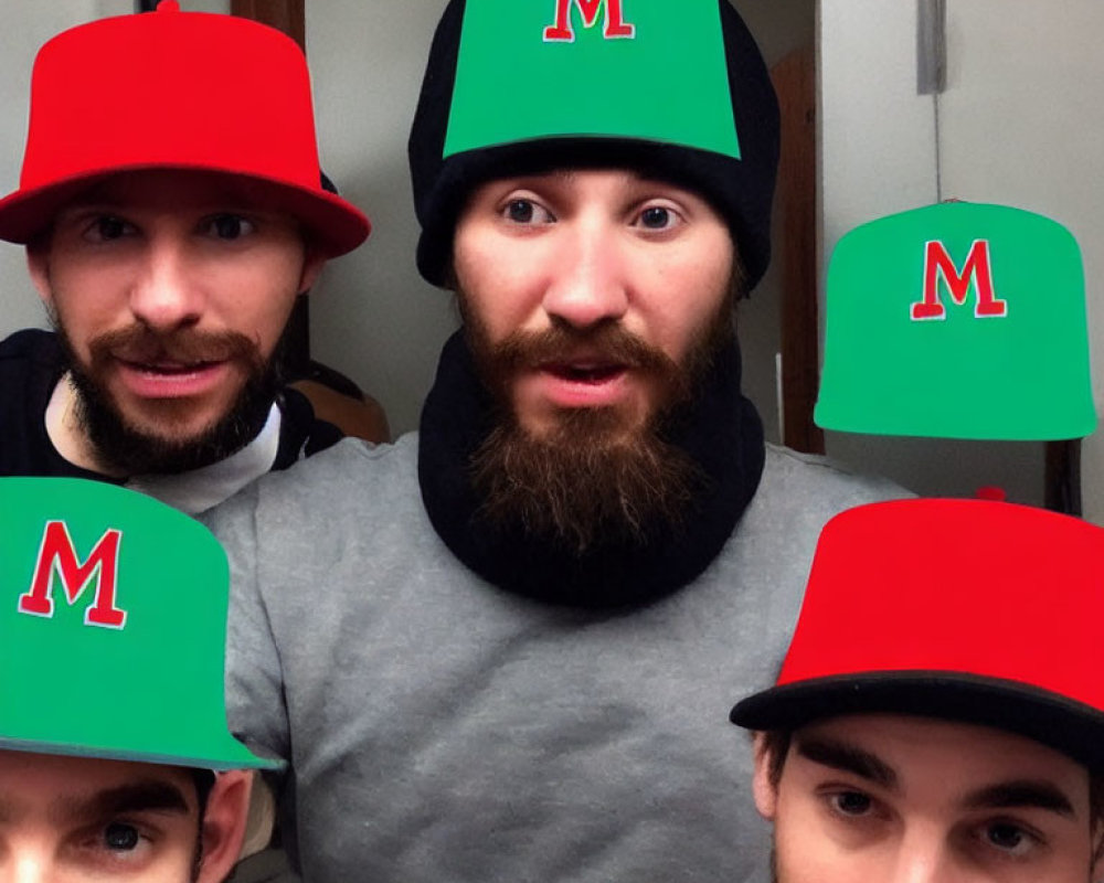 Four Men in Red and Green Hats with 'M' Letter in Small Room