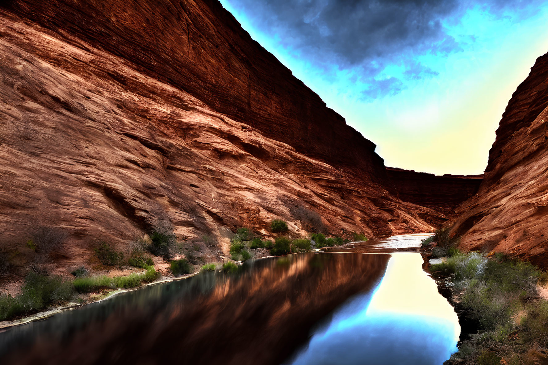 Tranquil river in red canyon under wispy cloud sky