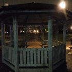 Tranquil night garden with illuminated gazebo and starlit sky