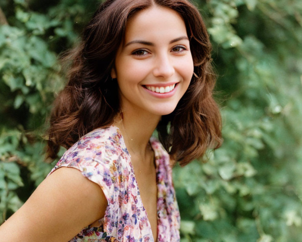 Smiling woman with brown hair in floral dress outdoors