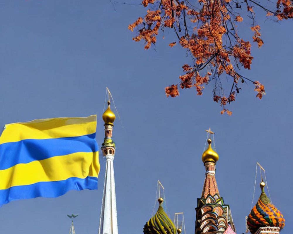 Ukrainian flag and Saint Basil's Cathedral under blue sky