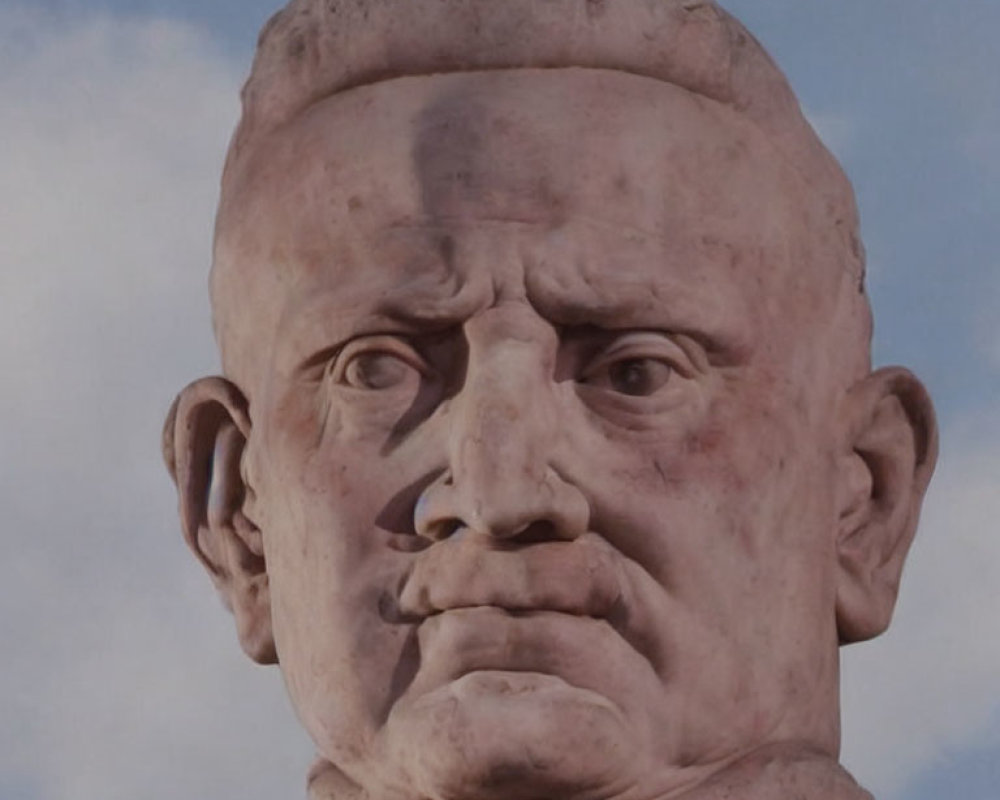 Weathered stone bust with realistic facial features against cloudy sky.