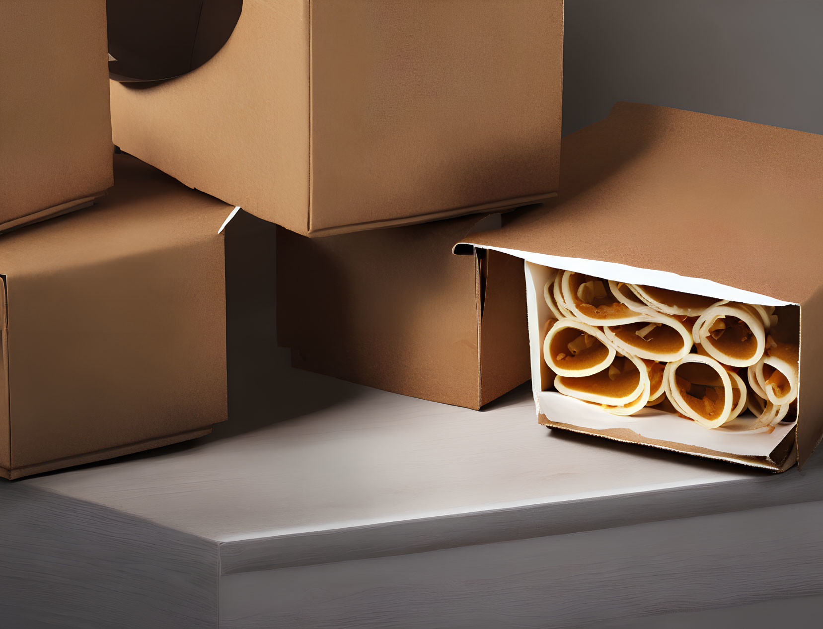 Stacked Cardboard Boxes with Spilled Packing Tape on White Surface