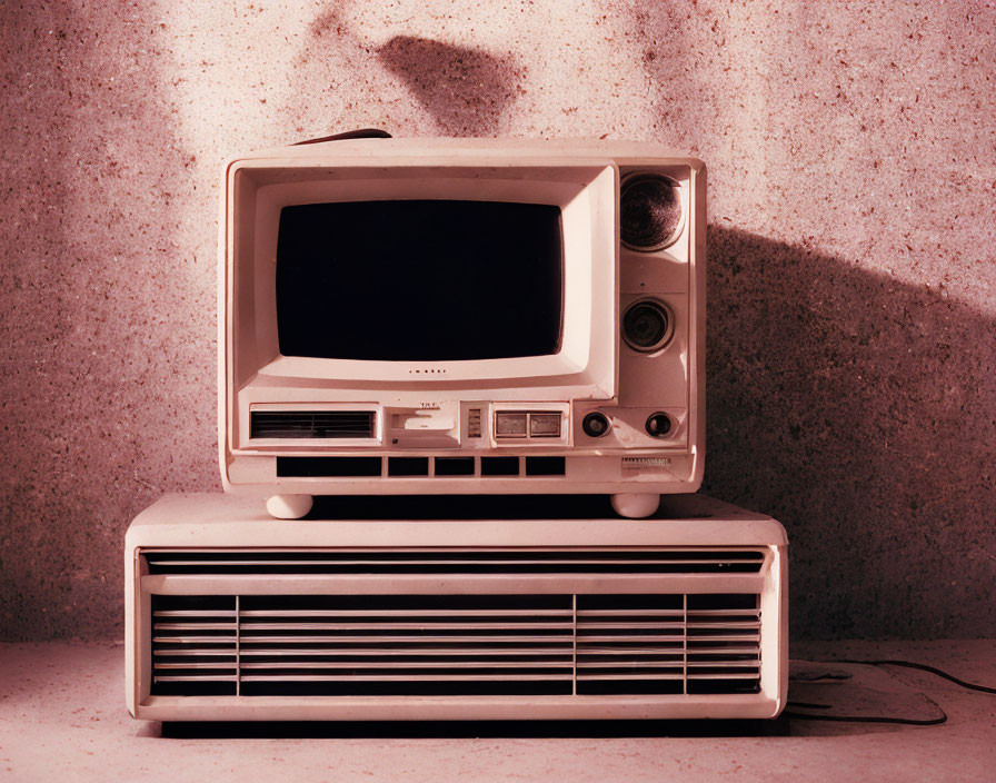 Vintage television on heater against textured wall - warm aesthetic