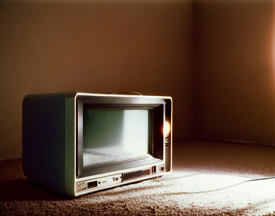 Vintage Television Set on Carpeted Floor with Warm Side Light