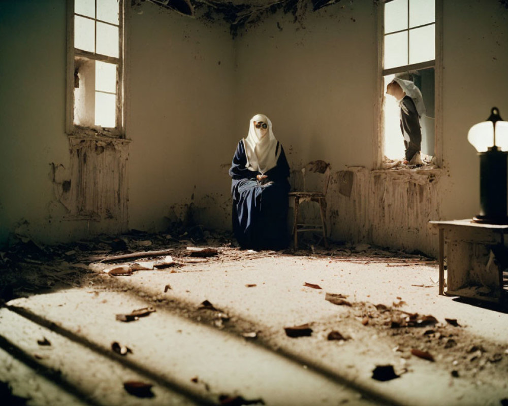 Person in hijab sits in dilapidated room with sunlight, debris, and lit lamp