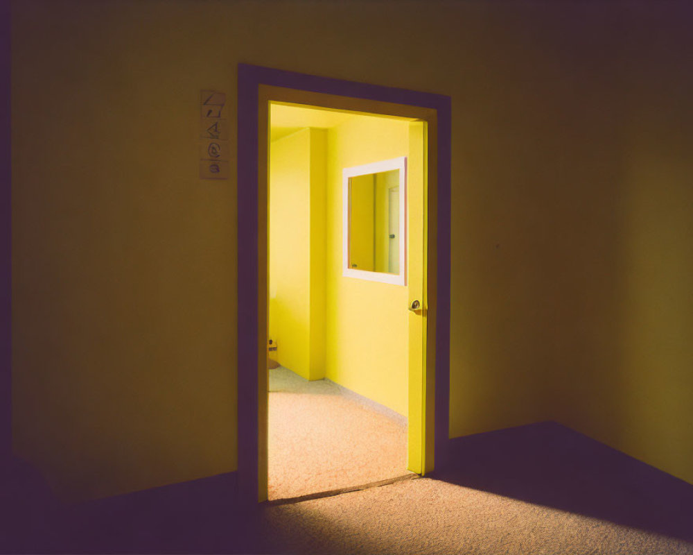 Yellow-lit room seen through an open door casting warm glow and shadows