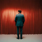 Person in Suit with Antlered Mask Standing in Front of Red Curtain