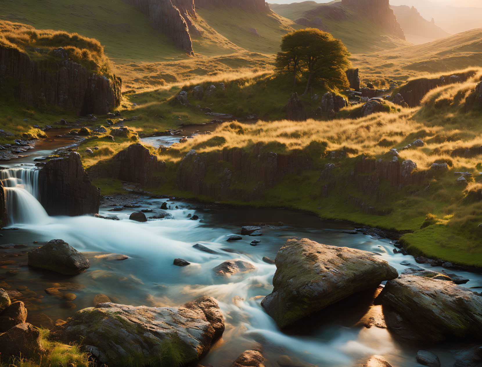 Sunset river landscape with rocky terrain and golden light