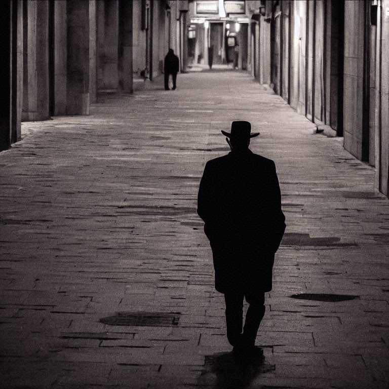 Mysterious figure in hat walks down dimly lit corridor at night