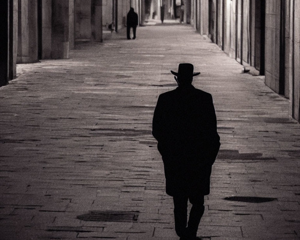 Mysterious figure in hat walks down dimly lit corridor at night