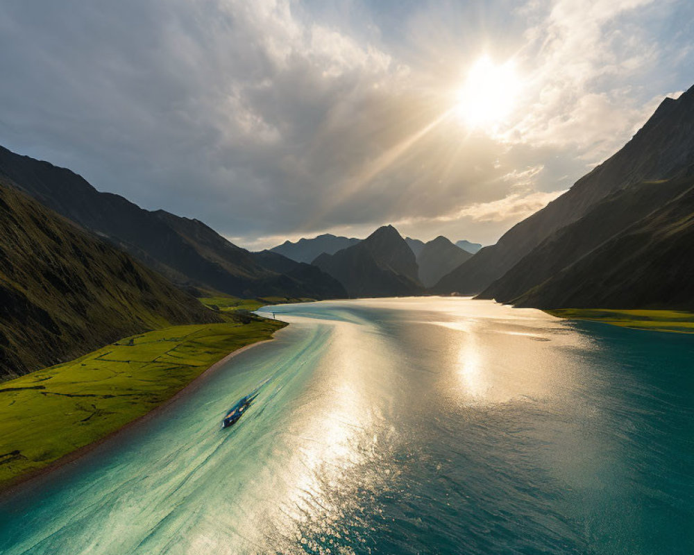 Serene mountainous lake at sunset with boat trail and dramatic sky