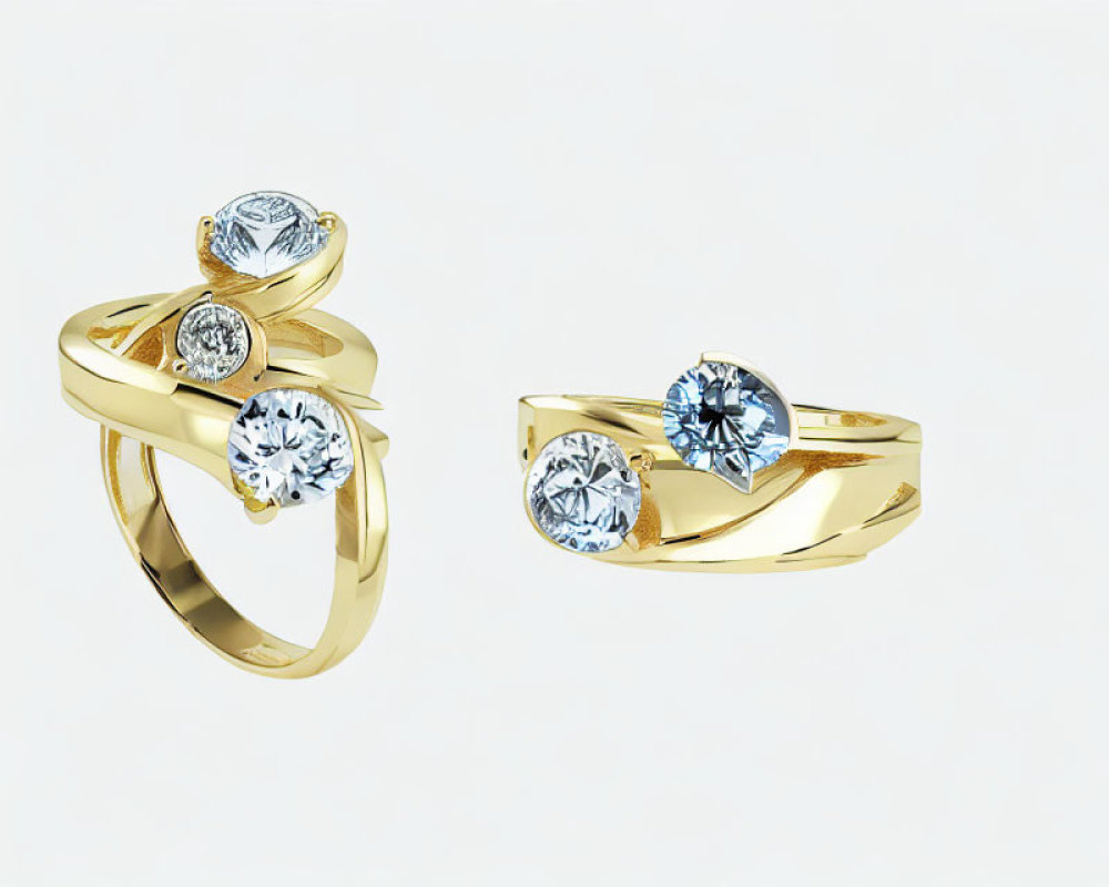 Gold rings with twist design and round-cut diamond against white background