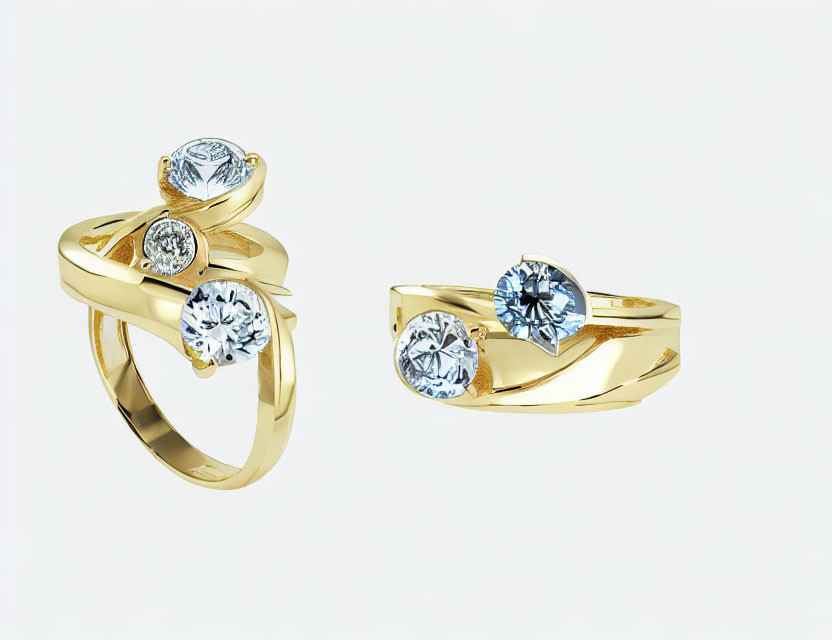 Gold rings with twist design and round-cut diamond against white background