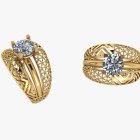 Ornate gold rings with filigree designs: diamonds and blue gemstone on white background