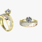 Gold rings with twist design and round-cut diamond against white background