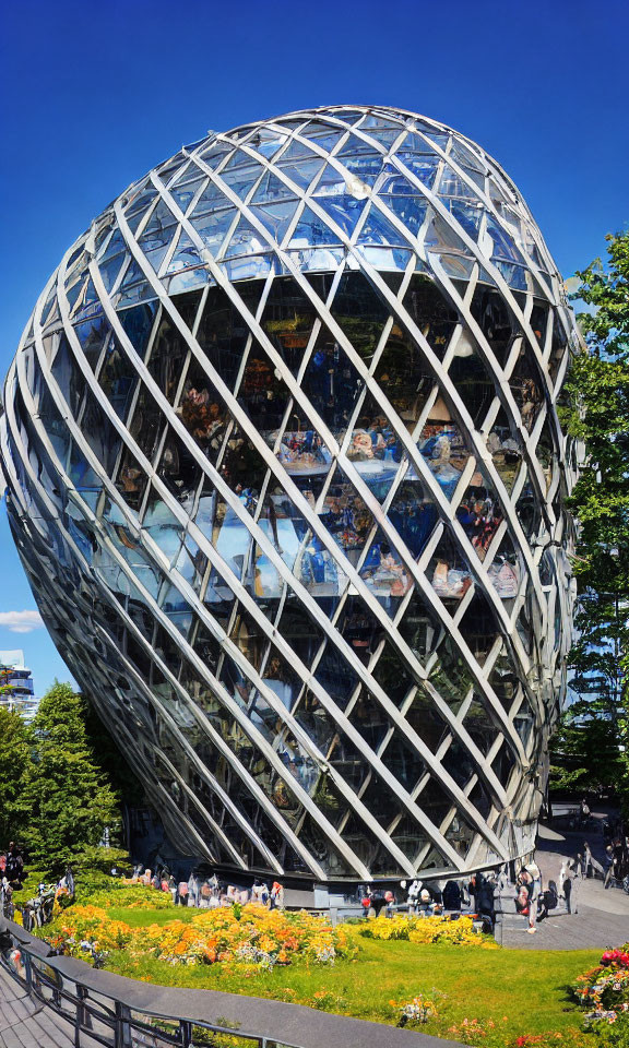 Egg-shaped building with geometric glass facade in lush green setting