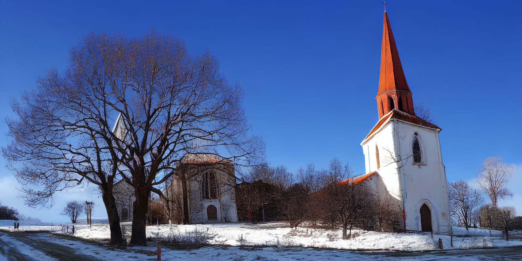 Serene winter scene with red spire church and snow-covered trees