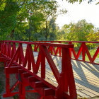 Colorful illustration: Red bridge, greenery, blue and white flowers, tranquil river.