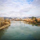 Tranquil landscape: colorful village by calm river