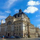 Colorful street scene with ornate orange building and blue sky