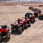 Camel caravan with riders crossing sandy desert trail