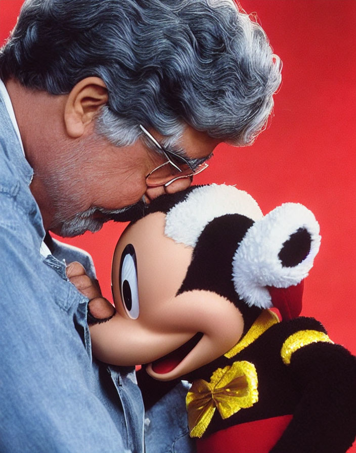 Gray-Haired Man Touches Foreheads with Mickey Mouse Plush Toy