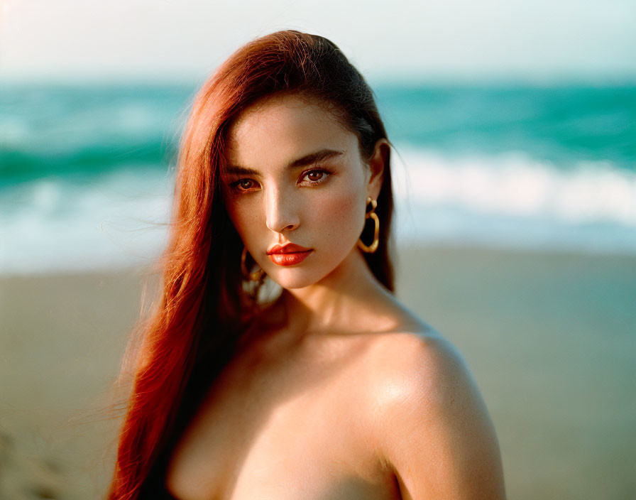 Woman with Long Red Hair and Hoop Earrings by Ocean Waves