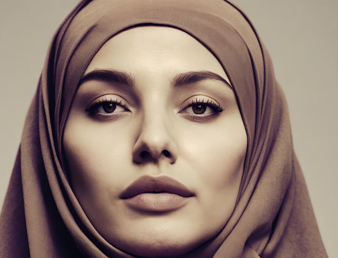 Portrait of woman in hijab with neutral expression and prominent eyes