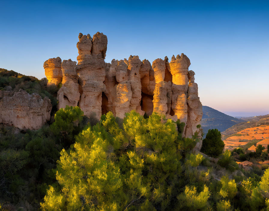 Sandstone Rock Formations in Golden Sunlight with Green Shrubs