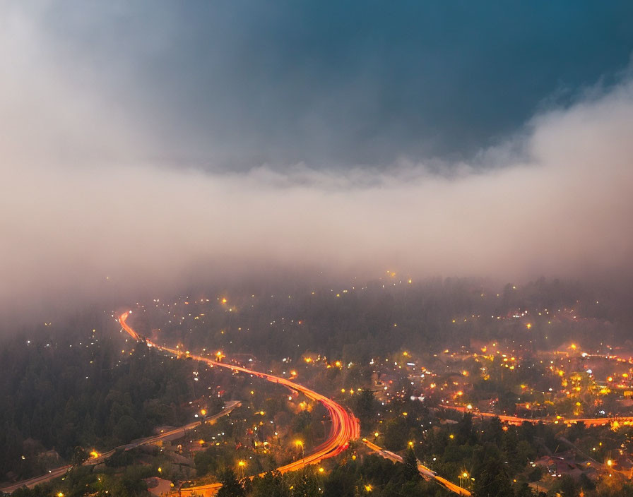 Curving road under stormy sky at dusk