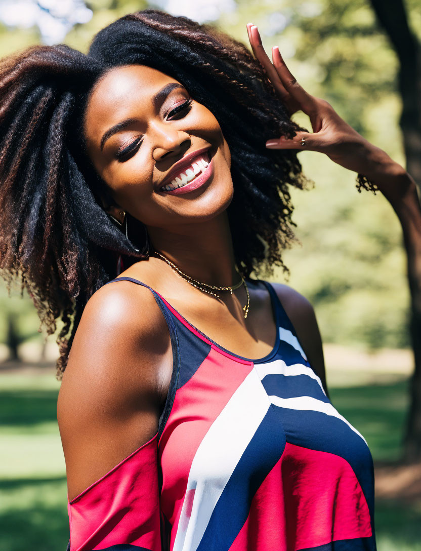 Smiling woman with afro hairstyle in colorful tank top poses playfully