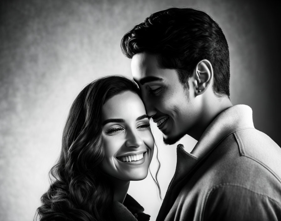 Monochrome image of smiling couple in close embrace