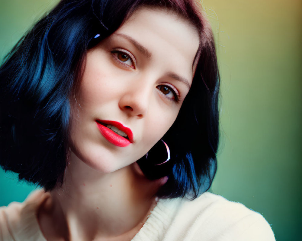 Portrait of Woman with Short Blue Hair and Red Lipstick in White Top and Hoop Earrings on