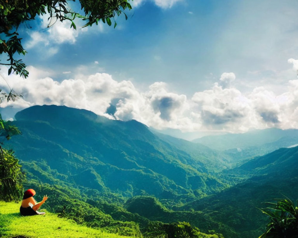 Person in Red Hat Sitting on Grassy Hill Overlooking Green Mountain Landscape