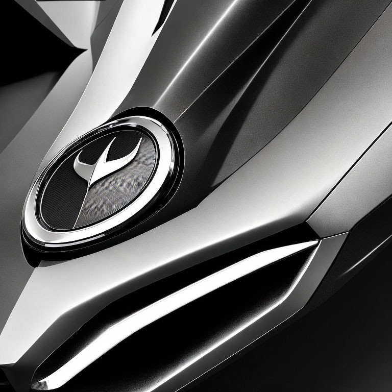 Grayscale close-up of metallic car badge and grille design