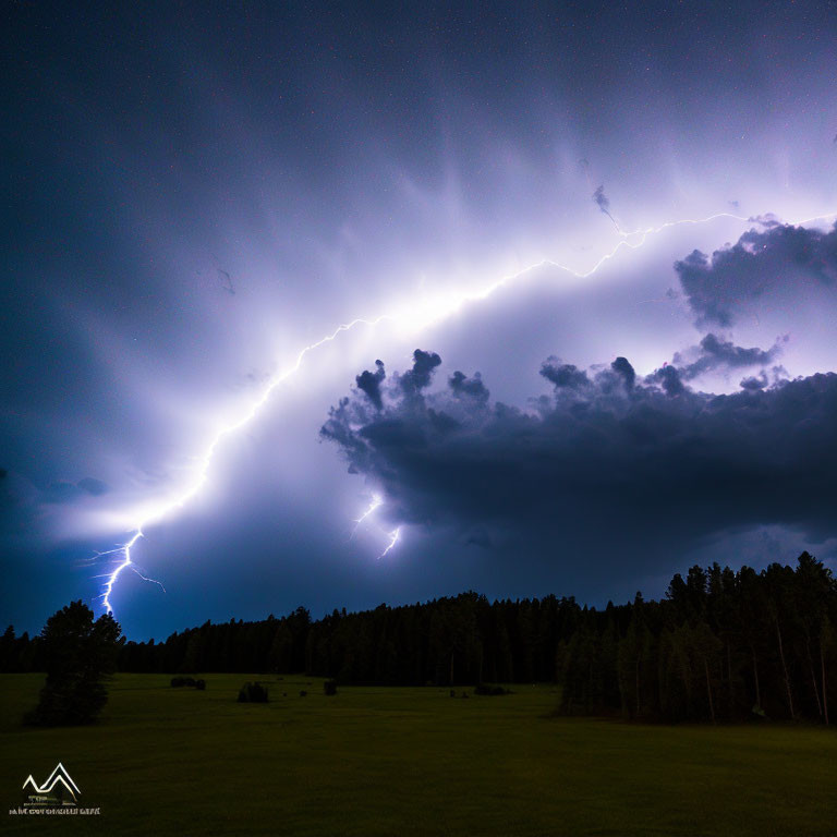 Bright lightning bolt in starry night sky over dark forest