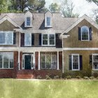 Charming two-story house with green exterior and white trim