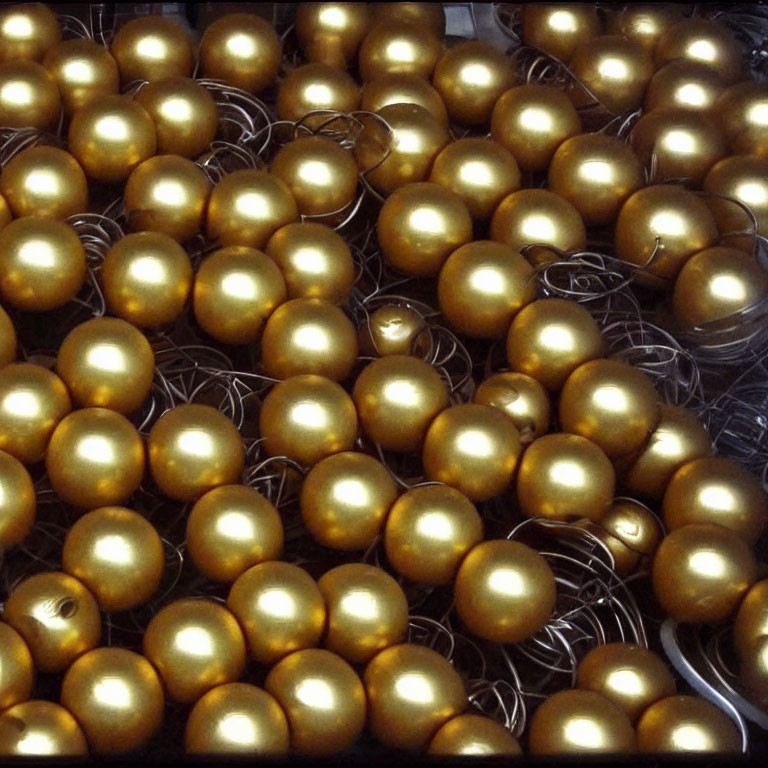 Shiny golden eggs in neat arrangement with metallic luster and glossy reflections