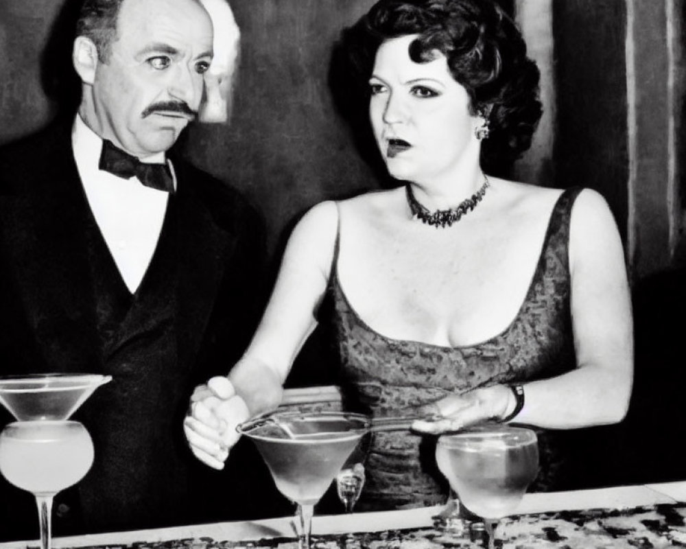 Vintage black and white photo of man and woman in formal attire near spilled cocktail