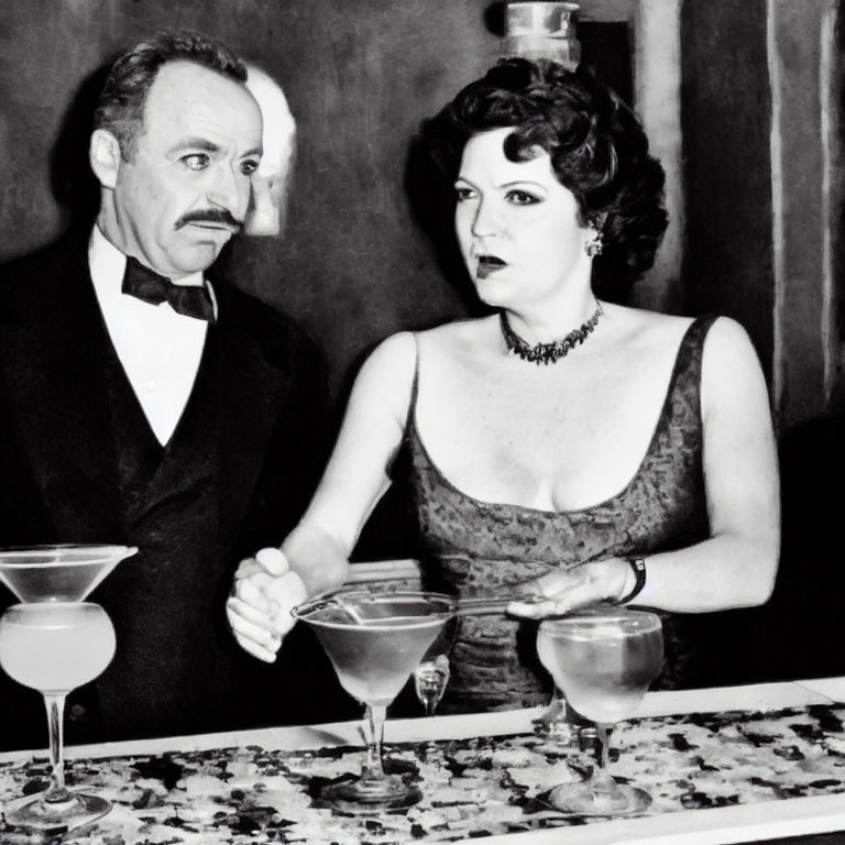 Vintage black and white photo of man and woman in formal attire near spilled cocktail