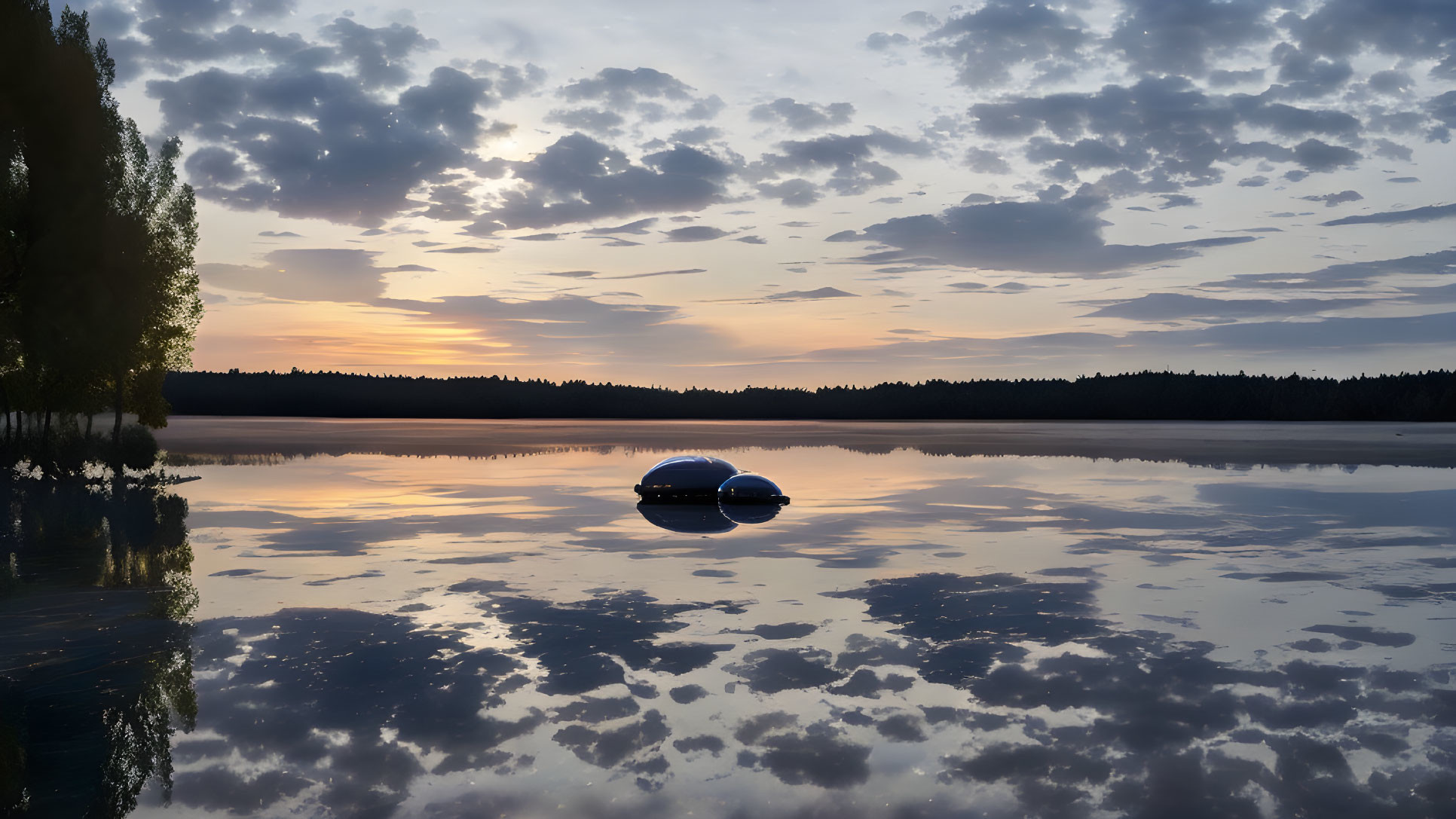 Tranquil lake scene with colorful sunset and small boat